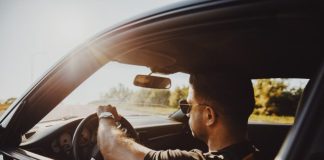 man in black jacket driving car during daytime