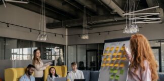 Free Group of People Sitting on Yellow Chairs Stock Photo