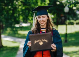 The Real Reasons for Getting a College Degree woman in academic dress wearing academic hat