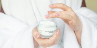 person holding white plastic container