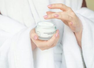 The Benefits of Moisturizers person holding white plastic container