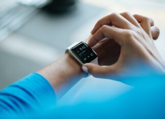 Home Health Monitoring: Why It’s Critical person clicking Apple Watch smartwatch