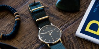 round silver-colored analog watch with black strap