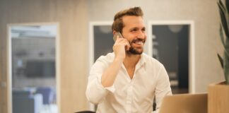 man using smartphone on chair