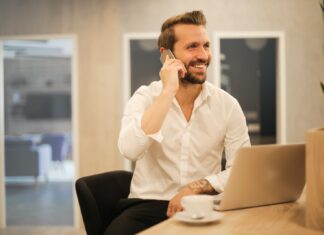 Methods through Which Small Businesses Can Lower Their Credit Card Processing Costs man using smartphone on chair