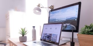 MacBook Pro on table beside white iMac and Magic Mouse