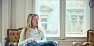 woman sitting on brown armchair
