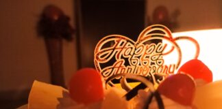 white cake with red cherry on top