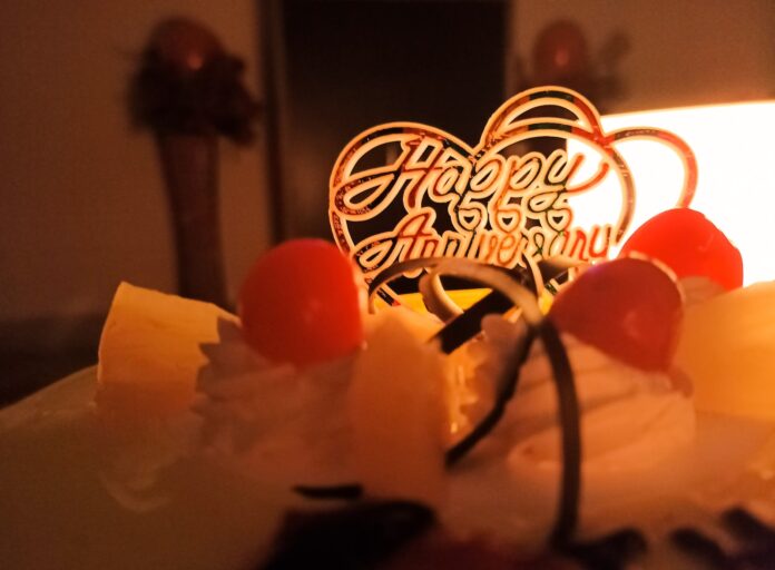 Photo by tanmay white cake with red cherry on top