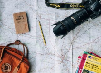 Impact of Bitcoin on the Travel Industry flat lay photography of camera, book, and bag