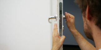 person holds door lever
