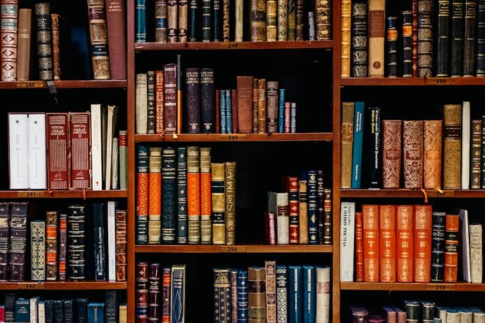 assorted-title-of-books-piled-in-the-shelves assorted-title of books piled in the shelves