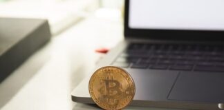 silver round coin on white table