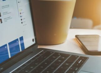 6 Essentials to Build a Successful Cloud Security Program white laptop computer turned on beside brown paper cup