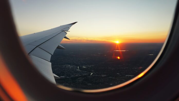 Photo by Eva Darron airplanes window view of sky during golden hour