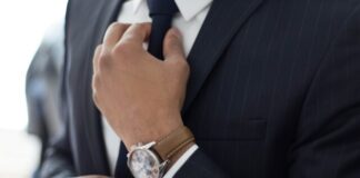 man wearing watch with black suit