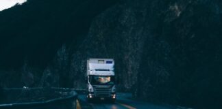 trailer truck passing on road near rail guard