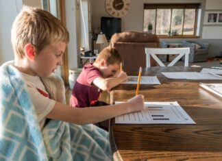 What Is the Best Time for Kids to Complete Their Homework? boy in gray crew neck t-shirt reading book