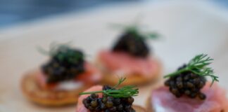 brown bread with green leaves on white ceramic plate