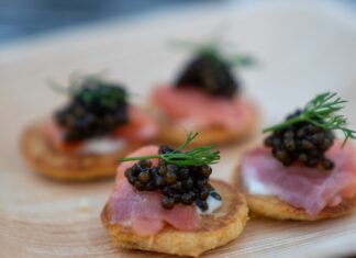 Top 5 Most Expensive Caviars in the World brown bread with green leaves on white ceramic plate