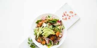 cooked food with sliced vegetables in white bowl