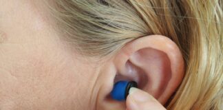 woman wearing blue stud earring