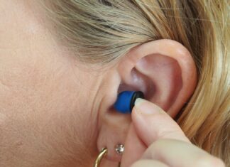 A Brief Look at the Amazing Technology of Today’s Hearing Aids woman wearing blue stud earring