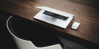 Apple MacBook beside computer mouse on table