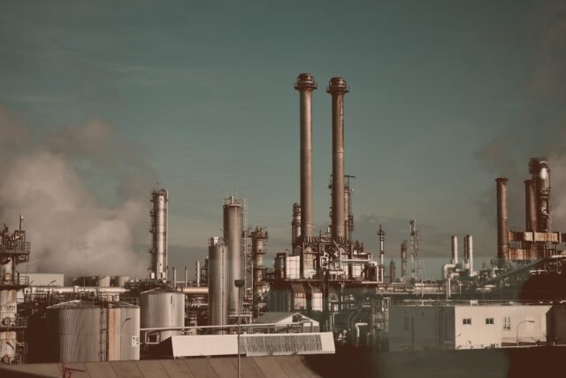 Photo by Ellie Meh factory under blue and white sky