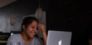 smiling woman using MacBook