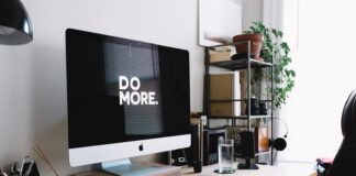 silver iMac with keyboard and trackpad inside room
