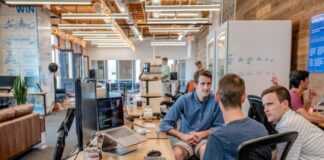 three men sitting on chair beside tables