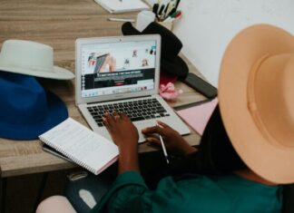 Top Tips for Traveling the World as a Freelancer person using macbook air on brown wooden table