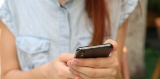 person holding using iPhone X