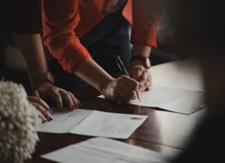Taking Restraining Orders Seriously: Why You Should Not Violate the Order Enforced Against You person in orange long sleeve shirt writing on white paper