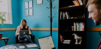 smiling man using black and gray laptop computer