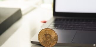 silver round coin on white table
