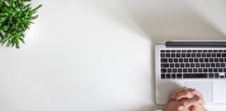 person wearing watch near laptop