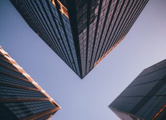 Why Do Companies Open Offshore low-angle photography of four high-rise buildings