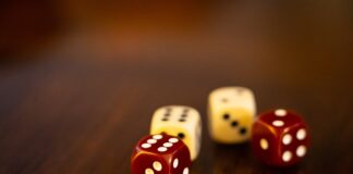 seven white and red dices on brown wooden table
