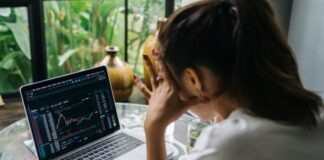 Woman Looking at Cryptocurrency Charts on Her Laptop
