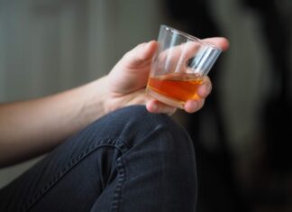 5 Celebrities That Have Successfully Overcome the Booze! Take Inspiration… person holding clear drinking glass with orange liquid
