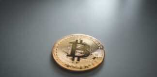 gold round coin on gray surface