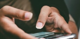 a close up of a person holding a cell phone