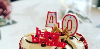 a red velvet birthday cake with white frosting