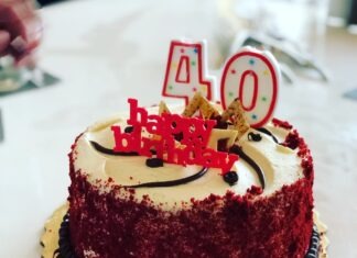 a red velvet birthday cake with white frosting