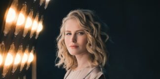woman standing beside lights