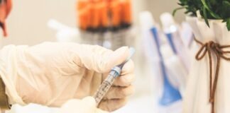 person holding white and black pen