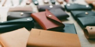 a table topped with lots of different types of wallets