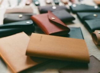 a table topped with lots of different types of wallets